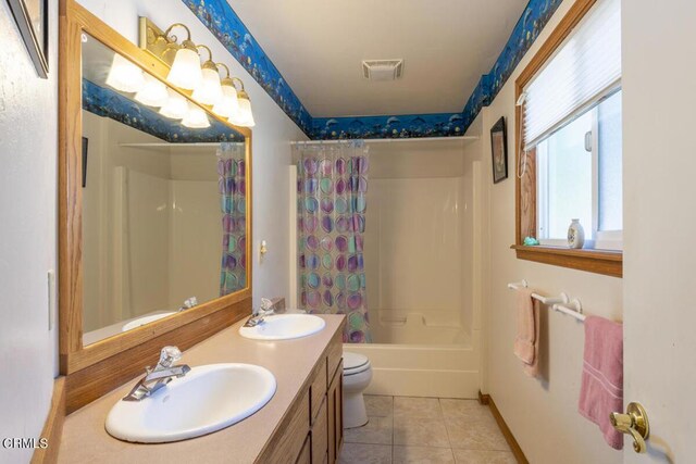 full bathroom featuring tile patterned floors, toilet, shower / tub combo with curtain, and double sink vanity