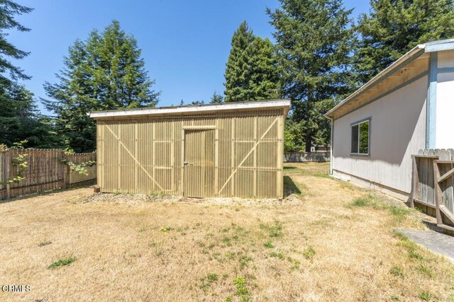 view of outbuilding with a yard