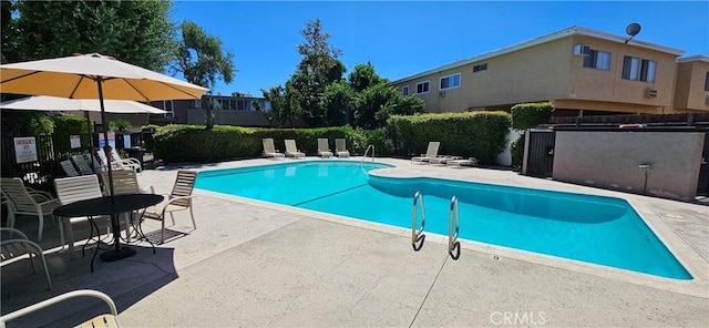 view of swimming pool featuring a patio area