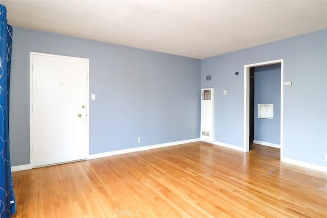 spare room with wood-type flooring