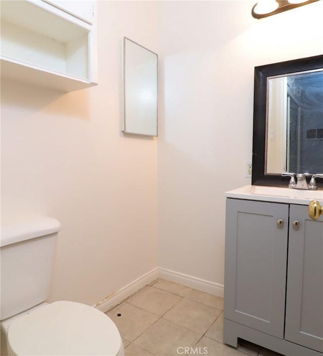 bathroom featuring tile patterned flooring, vanity, and toilet