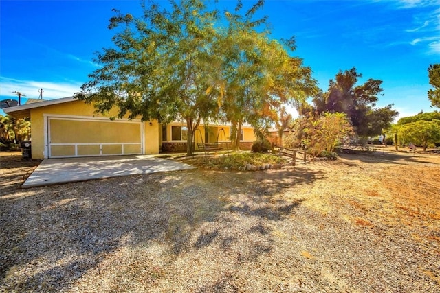 obstructed view of property with a garage