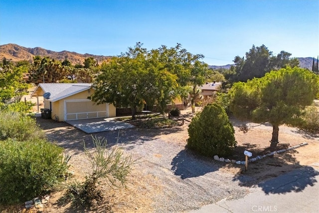 obstructed view of property featuring a mountain view and a garage