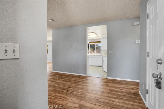 interior space with light hardwood / wood-style flooring and a textured ceiling