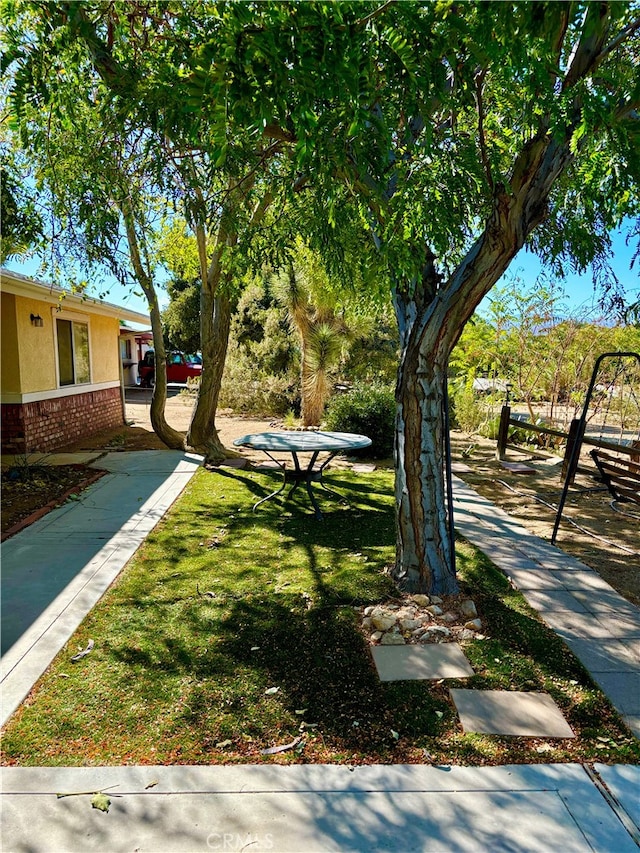 view of home's community with a yard