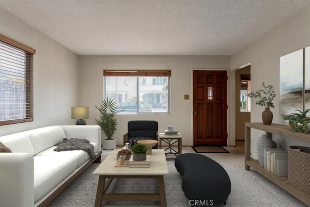 living room with a textured ceiling, light colored carpet, and a wealth of natural light