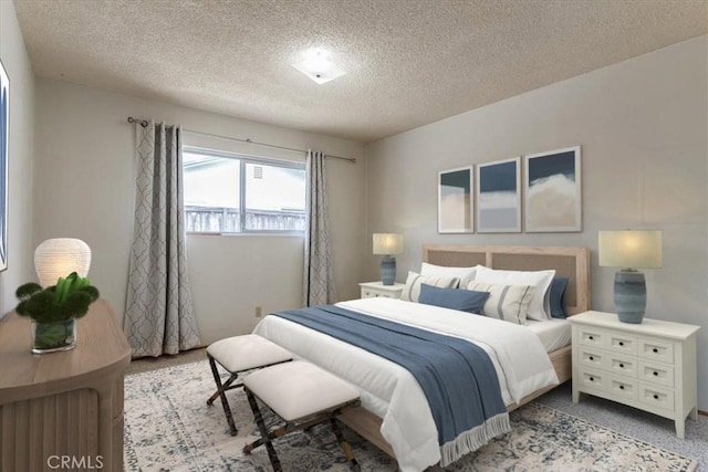 bedroom featuring carpet floors and a textured ceiling