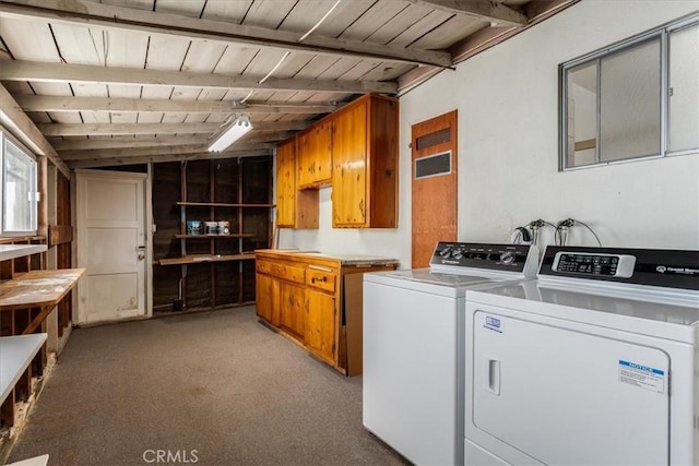 clothes washing area featuring light carpet, washer and clothes dryer, and wood ceiling