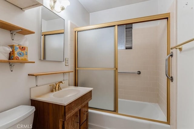 full bathroom with vanity, combined bath / shower with glass door, and toilet