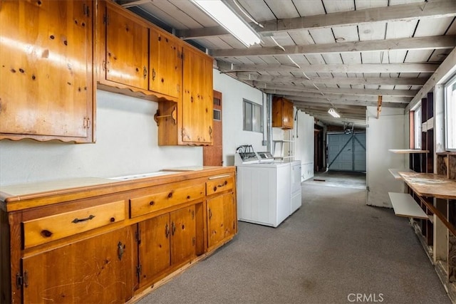 kitchen with washing machine and clothes dryer, light carpet, wooden ceiling, and beam ceiling