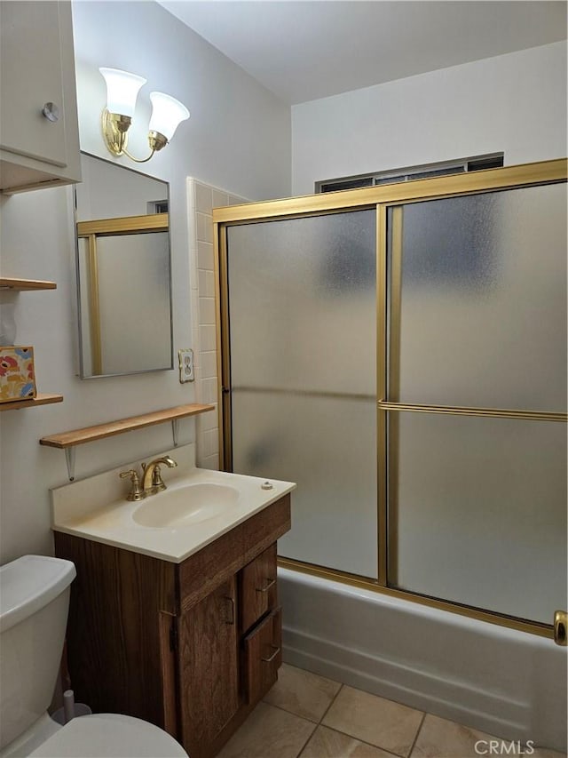 full bathroom featuring tile patterned flooring, vanity, enclosed tub / shower combo, and toilet