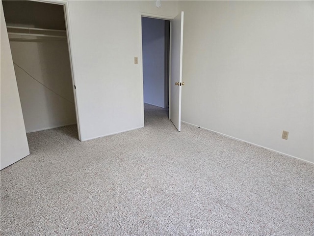 unfurnished bedroom featuring a closet and carpet floors