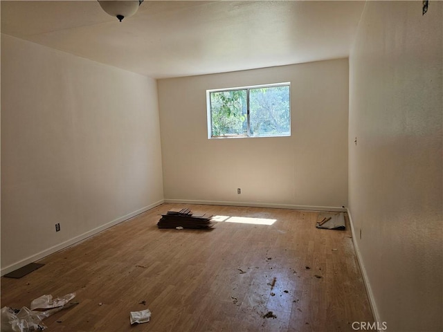 spare room featuring wood-type flooring