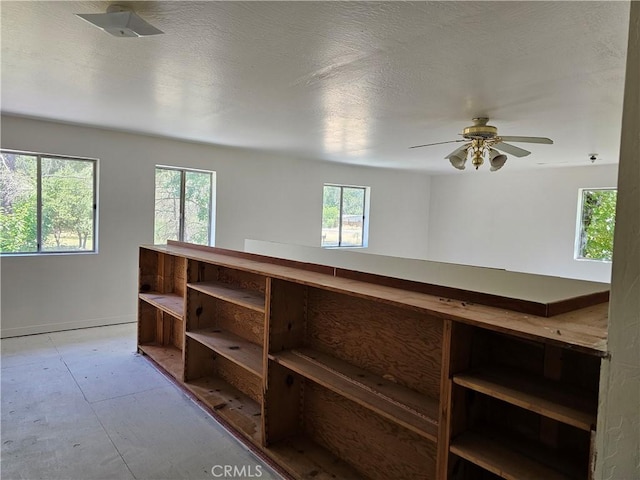 interior space featuring plenty of natural light and a textured ceiling