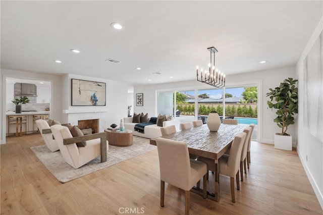 dining room with a chandelier and light hardwood / wood-style floors