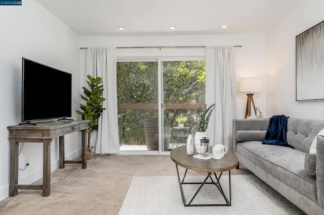 living room with a wealth of natural light and light carpet