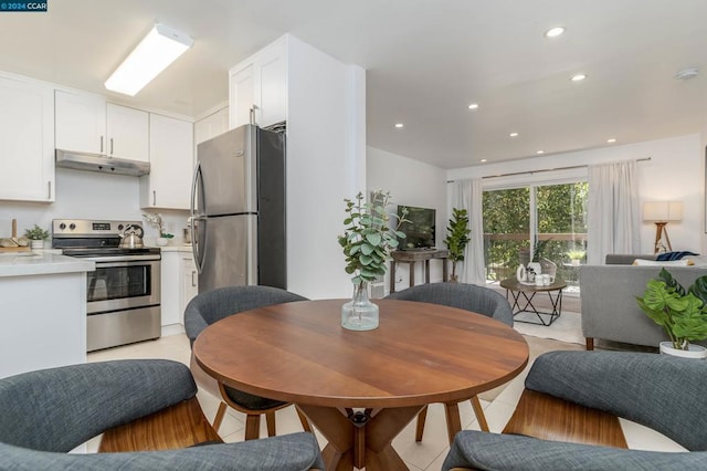 kitchen with white cabinets, appliances with stainless steel finishes, and light tile patterned flooring