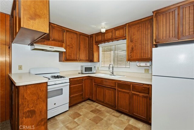 kitchen with sink and white appliances