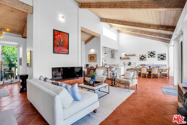 tiled living room with beam ceiling, wood ceiling, and high vaulted ceiling