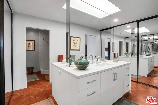 bathroom featuring a shower, tile patterned floors, and vanity