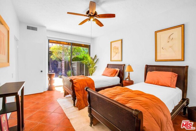 bedroom featuring ceiling fan, access to exterior, and tile patterned flooring