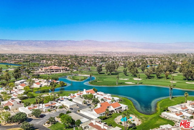 birds eye view of property with a water and mountain view