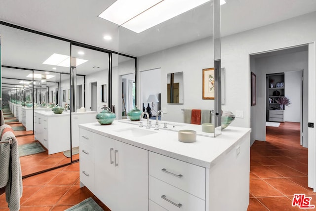 bathroom featuring tile patterned flooring and vanity