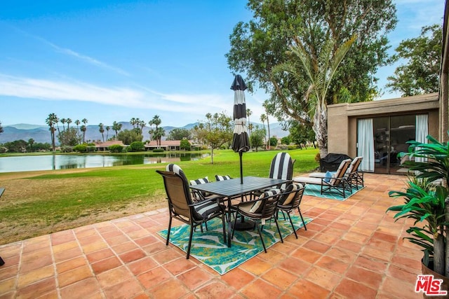 view of patio featuring a water and mountain view