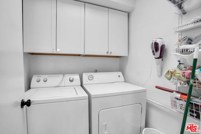 laundry area featuring cabinets and washing machine and clothes dryer