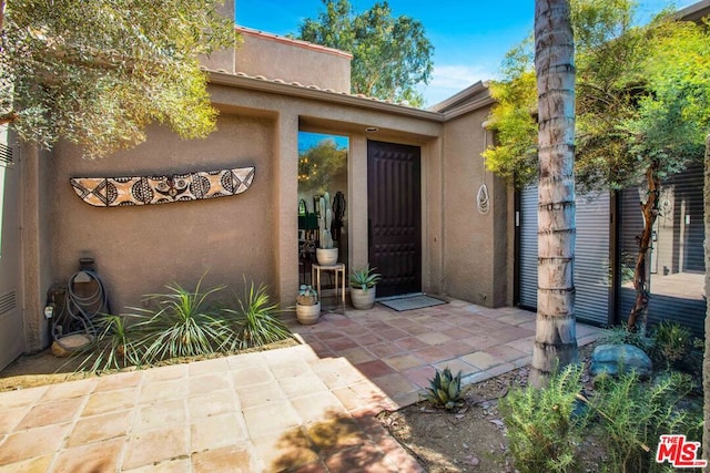 entrance to property featuring a patio area