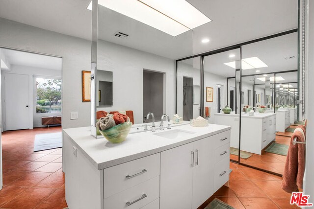 bathroom with vanity and tile patterned floors