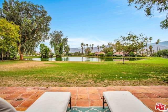 view of yard featuring a patio area and a water view