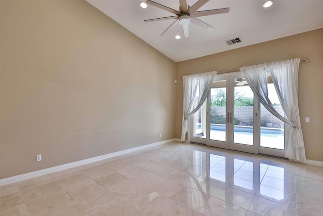 empty room featuring french doors, lofted ceiling, light tile patterned floors, and ceiling fan