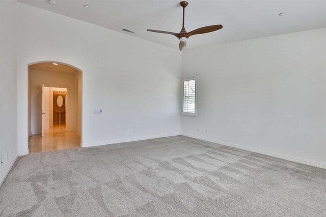 carpeted spare room featuring ceiling fan