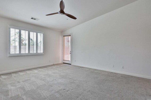 carpeted spare room featuring lofted ceiling and ceiling fan