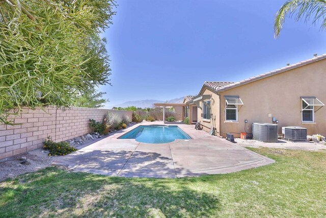 view of pool featuring a lawn, central AC unit, and a patio area