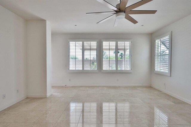 unfurnished room with light tile patterned floors and ceiling fan