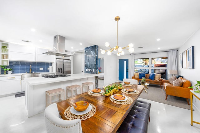 dining space with a notable chandelier and sink