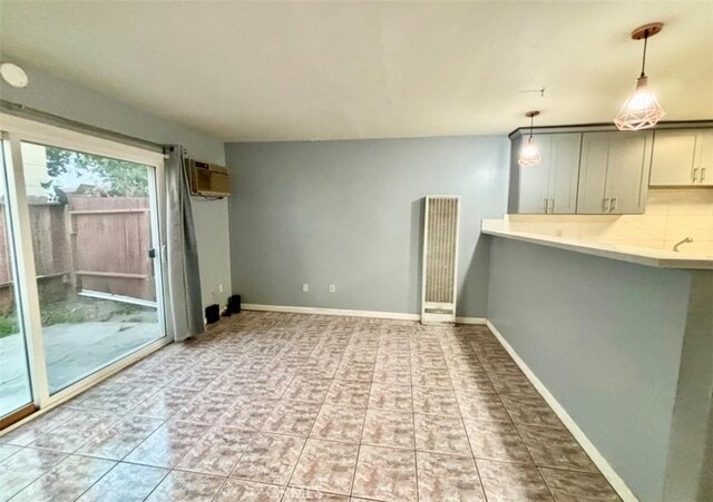 unfurnished room with a wall mounted AC and light tile patterned floors