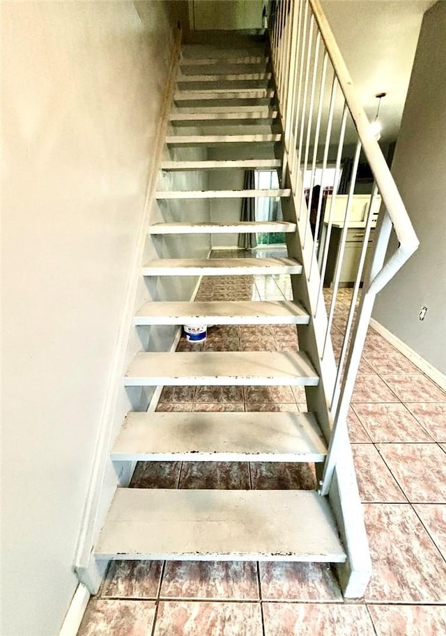 stairway featuring tile patterned floors