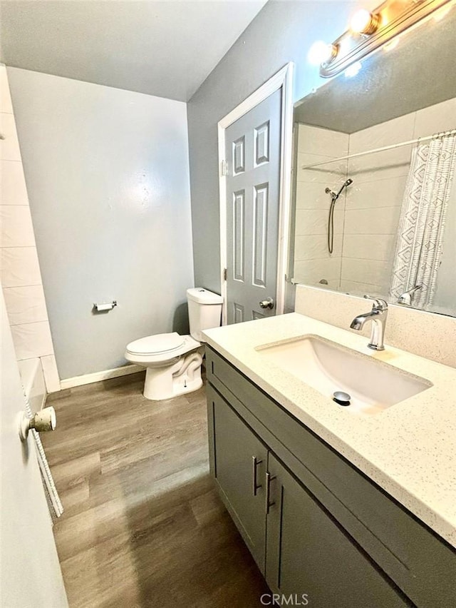 bathroom with vanity, hardwood / wood-style floors, and toilet