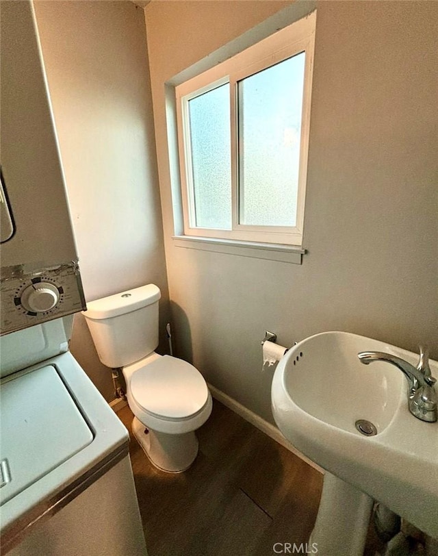 bathroom featuring wood-type flooring, sink, and toilet