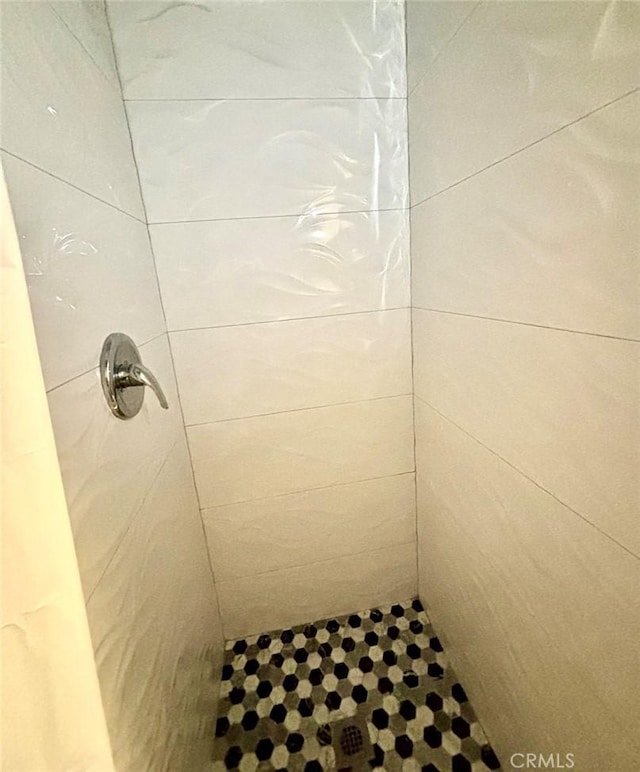 bathroom with tiled shower