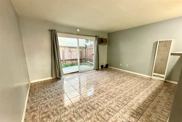 tiled empty room with a wall mounted AC