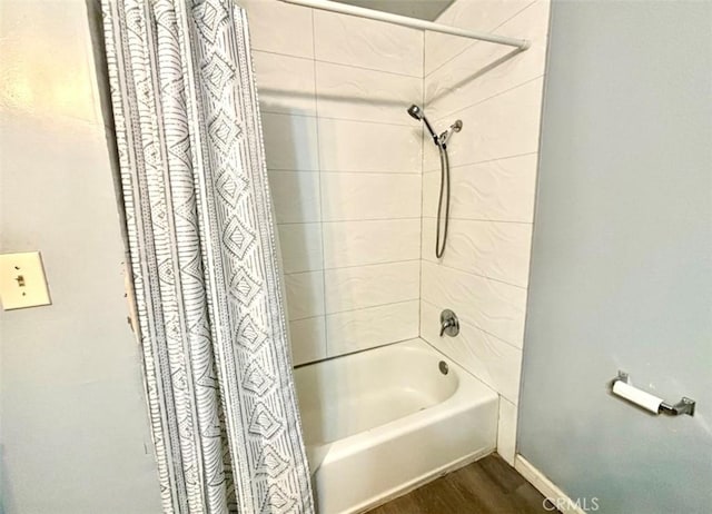 bathroom featuring shower / tub combo with curtain and wood-type flooring