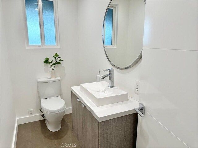 23028 W Mobile St, West Hills, CA 91307 - half bath with vanity, toilet, tile patterned flooring, and baseboards