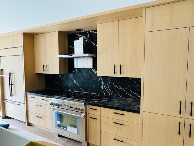 kitchen with light brown cabinetry, decorative backsplash, and high quality appliances