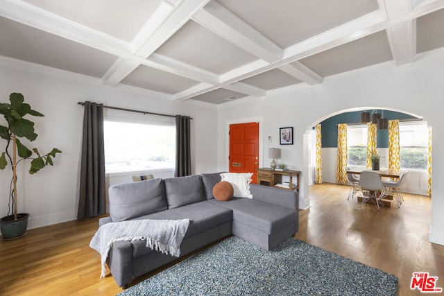 living room with coffered ceiling, beam ceiling, a healthy amount of sunlight, and hardwood / wood-style floors