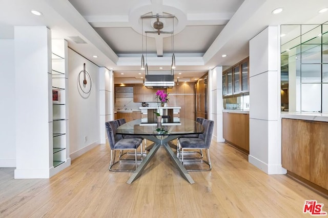 dining space with light wood-type flooring, beamed ceiling, and coffered ceiling