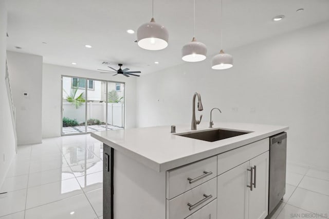 kitchen with white cabinetry, sink, hanging light fixtures, stainless steel dishwasher, and a center island with sink